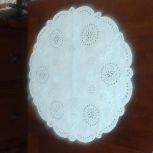 White linen table rounder with elaborate embroidery, flowers, eyelets,